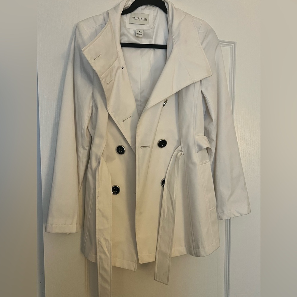 White trench coat with black buttons